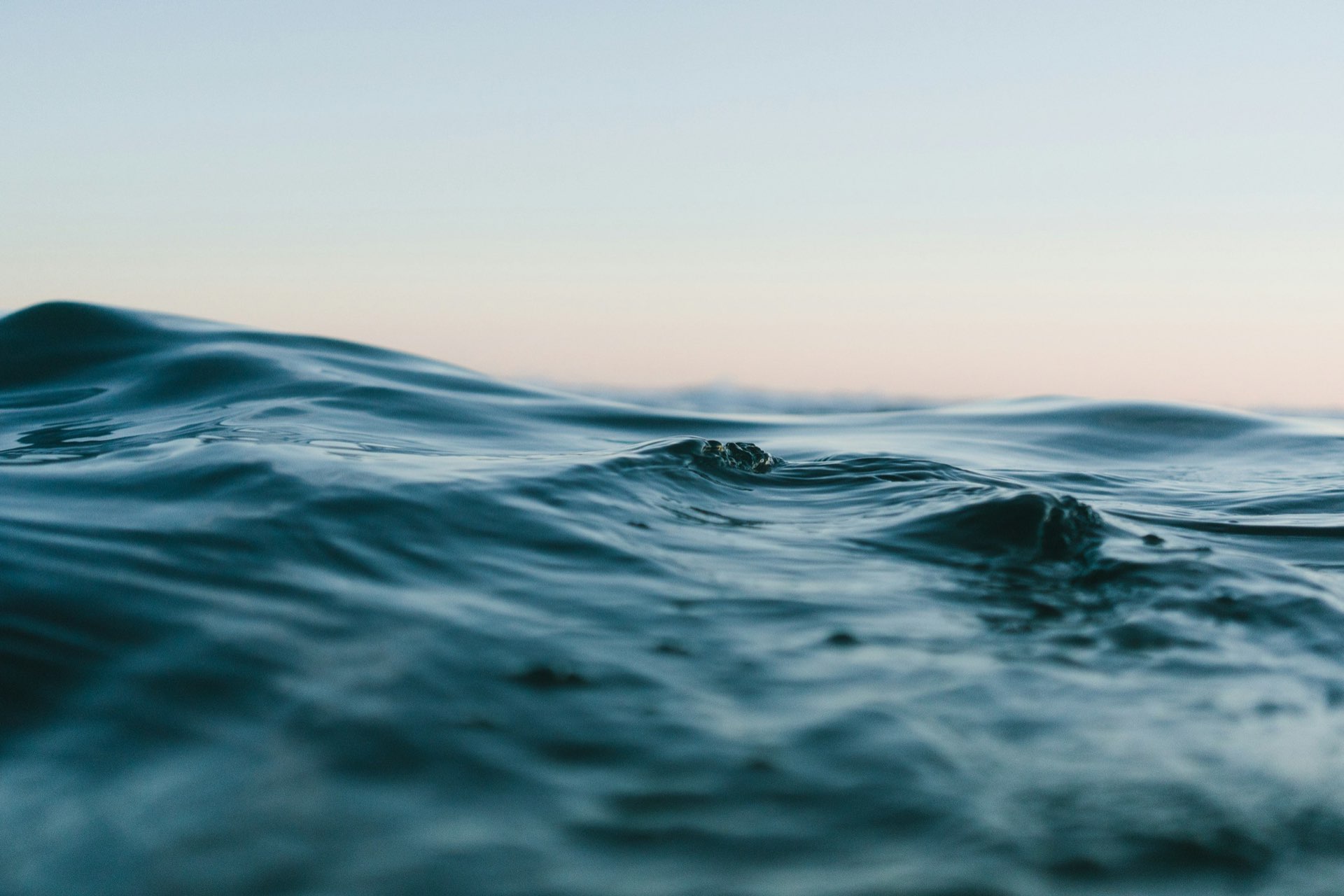 A calm sea at dusk with soft light on gentle waves
